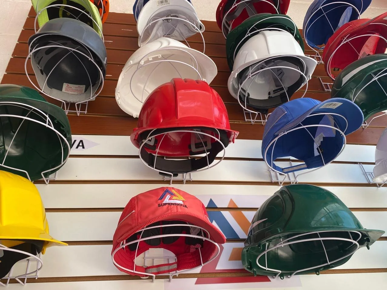 Exhibidor de cascos de seguridad de colores en la tienda Supernova